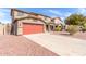 Two-story home featuring a red two-car garage, a tile roof, and a driveway with low-maintenance landscaping at 2190 W San Tan Hills Dr, San Tan Valley, AZ 85144