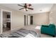 Spacious main bedroom featuring a ceiling fan, seating area, and en-suite bathroom at 2190 W San Tan Hills Dr, San Tan Valley, AZ 85144