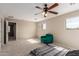 Large main bedroom featuring carpet, windows for natural light, ceiling fan and ensuite bathroom at 2190 W San Tan Hills Dr, San Tan Valley, AZ 85144