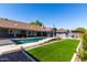 Lush backyard showcasing a refreshing pool, well-maintained lawn, and mature landscaping at 2237 N Kachina --, Mesa, AZ 85203