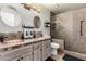 Charming bathroom featuring dual copper sinks, decorative tile, and a glass-enclosed shower at 2237 N Kachina --, Mesa, AZ 85203