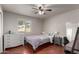 Comfortable bedroom with wood floors, a ceiling fan, and a bright window at 2237 N Kachina --, Mesa, AZ 85203