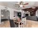 Inviting dining room with hardwood table, ceiling fan, and views into the living room area at 2237 N Kachina --, Mesa, AZ 85203