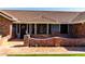 Inviting front porch with brick accents, a tiled walkway, and a charming entrance door at 2237 N Kachina --, Mesa, AZ 85203