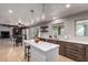 Modern kitchen with an island open to the living area with dark wood and white cabinets, and tile floors at 2237 N Kachina --, Mesa, AZ 85203