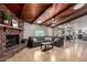 Comfortable living room featuring a brick fireplace, wood beam ceilings, and a gray couch at 2237 N Kachina --, Mesa, AZ 85203