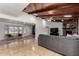 Bright living room with wood beam ceilings, a cozy fireplace, and gray sofa at 2237 N Kachina --, Mesa, AZ 85203