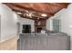 Cozy living room with brick fireplace, wood beam ceiling, and comfortable gray sofa at 2237 N Kachina --, Mesa, AZ 85203