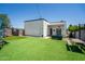 Backyard featuring artificial turf, seating area, and modern home exterior at 2246 E Sheridan St, Phoenix, AZ 85006