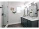 Stylish bathroom showcasing a double vanity with marble countertop and a glass-enclosed shower at 2246 E Sheridan St, Phoenix, AZ 85006