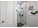 Modern bathroom featuring a glass-enclosed shower with tiled walls and a black tiled floor at 2246 E Sheridan St, Phoenix, AZ 85006