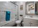 Well-lit bathroom with a shower over the tub, tiled walls, vanity, and decorated with modern finishes at 2246 E Sheridan St, Phoenix, AZ 85006