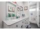 Bright bathroom with dual sink vanity and decorative beach themed wall art and stylish tiled shower at 2246 E Sheridan St, Phoenix, AZ 85006