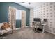 Stylized bedroom with accent wall, floral curtains, and a comfortable workspace at 2246 E Sheridan St, Phoenix, AZ 85006
