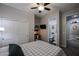 Bedroom featuring a bed, a ceiling fan, a desk with a chair, a closet, and access to a bathroom at 2246 E Sheridan St, Phoenix, AZ 85006