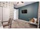 Comfortable bedroom with modern decor, accent wall, and direct access to an adjacent room at 2246 E Sheridan St, Phoenix, AZ 85006