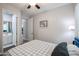 Bedroom featuring a bed, a ceiling fan, a desk with a chair, and access to two bathrooms at 2246 E Sheridan St, Phoenix, AZ 85006