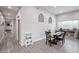 Bright dining area with decorative wall accents, a dark wood table, and plank flooring at 2246 E Sheridan St, Phoenix, AZ 85006