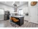 Modern kitchen with stainless steel appliances, a stylish island, and white cabinetry at 2246 E Sheridan St, Phoenix, AZ 85006