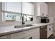 Close up on a kitchen with bright white countertops and cabinetry, and stainless steel appliances at 2246 E Sheridan St, Phoenix, AZ 85006