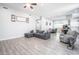 Open-concept living room with stylish gray sofa flowing seamlessly into dining and kitchen areas at 2246 E Sheridan St, Phoenix, AZ 85006