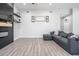 Bright living room featuring a stylish gray sofa and a sleek fireplace with floating shelves at 2246 E Sheridan St, Phoenix, AZ 85006