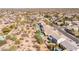 Desert neighborhood aerial view featuring backyard pools and desert landscaping, near a paved road at 26234 N 46Th St, Phoenix, AZ 85050