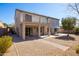 A spacious backyard featuring a covered patio, balcony, gravel landscaping, and mature trees at 26234 N 46Th St, Phoenix, AZ 85050