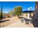 Enjoy the well-maintained backyard with a gravel area and a blue patio umbrella at 26234 N 46Th St, Phoenix, AZ 85050