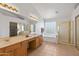 Bright bathroom boasting double sinks, tiled floors, garden tub, and a glass enclosed shower at 26234 N 46Th St, Phoenix, AZ 85050