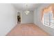 Dining room featuring carpeted floors, bright window, and a chandelier at 26234 N 46Th St, Phoenix, AZ 85050