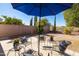 Relaxing outdoor patio with comfortable seating under a large blue umbrella at 26234 N 46Th St, Phoenix, AZ 85050