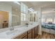 Bathroom with a double sink vanity, framed mirrors, and natural light at 2673 S Balsam Dr, Gilbert, AZ 85295