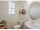 Powder room featuring a modern sink with a mirror and natural light from the shuttered window at 2673 S Balsam Dr, Gilbert, AZ 85295