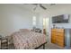 Well-lit bedroom with ceiling fan, desk and view to the bathroom at 2673 S Balsam Dr, Gilbert, AZ 85295