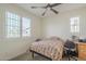 A cozy bedroom with large windows and a ceiling fan at 2673 S Balsam Dr, Gilbert, AZ 85295