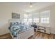 Comfortable bedroom featuring hardwood floors, a large bed, and a bright window area with a desk at 2673 S Balsam Dr, Gilbert, AZ 85295