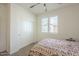 A cozy bedroom with large windows and a closet at 2673 S Balsam Dr, Gilbert, AZ 85295