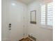 Bright entryway with coat rack and mirror, enhanced by natural light from the window at 2673 S Balsam Dr, Gilbert, AZ 85295