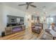 Open-concept living room with an entertainment center, fireplace, and hardwood flooring at 2673 S Balsam Dr, Gilbert, AZ 85295