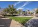 Neighborhood playground with blue play equipment and soft green grass under a partly cloudy sky at 2673 S Balsam Dr, Gilbert, AZ 85295