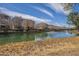 Scenic community pond with multiple buildings along the shoreline and a fountain at 2673 S Balsam Dr, Gilbert, AZ 85295