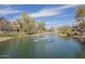 Community pond view with fountains surrounded by green space and walking path at 2673 S Balsam Dr, Gilbert, AZ 85295