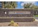 Stone community sign for The Lakes at Annecy in a landscaped entrance at 2673 S Balsam Dr, Gilbert, AZ 85295