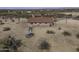 An aerial view of a home with a desert landscape featuring an aviary, and minimal foliage at 27141 E Javelina Dr, Florence, AZ 85132