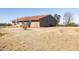 Back exterior view of a single story home with a red tile roof and desert landscape at 27141 E Javelina Dr, Florence, AZ 85132