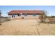 Back exterior view of a single story home with brick facade, red tile roof, and desert landscape at 27141 E Javelina Dr, Florence, AZ 85132