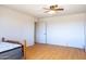 Bright bedroom with laminate floors, a ceiling fan, and a closet at 27141 E Javelina Dr, Florence, AZ 85132