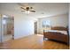 Bedroom with a ceiling fan, laminate floors, and a bathroom and closet at 27141 E Javelina Dr, Florence, AZ 85132