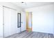 Bedroom with vinyl wood flooring, closet, and view to the doorway of an adjacent room at 27141 E Javelina Dr, Florence, AZ 85132